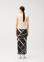 A model wears the PLEATS PLEASE ISSEY MIYAKE FOLD LINE fold-line-skirt-charcoal.