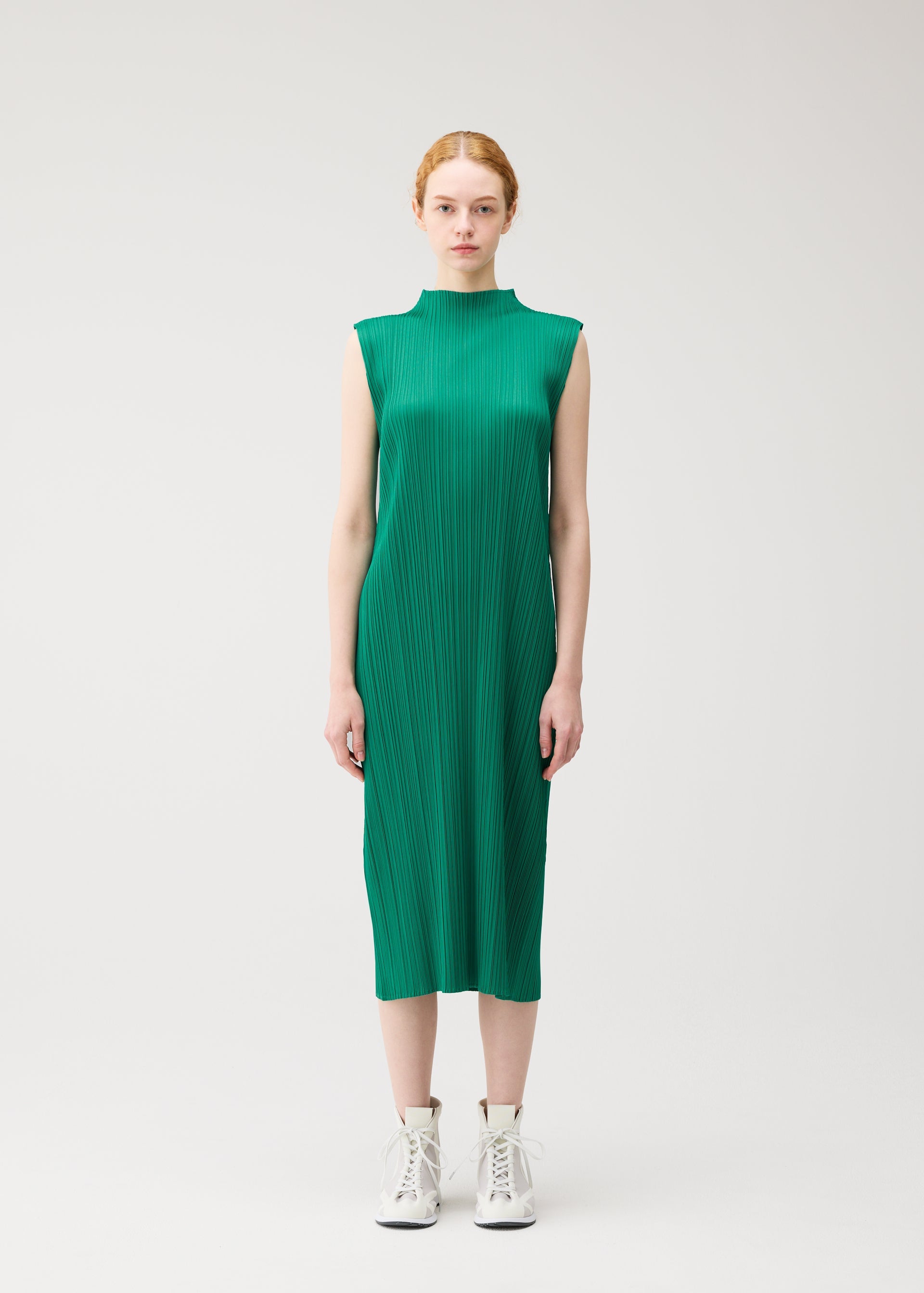 A model wears the PLEATS PLEASE ISSEY MIYAKE MONTHLY COLORS : JULY monthly-colors-july-dress-pale-orange-1.