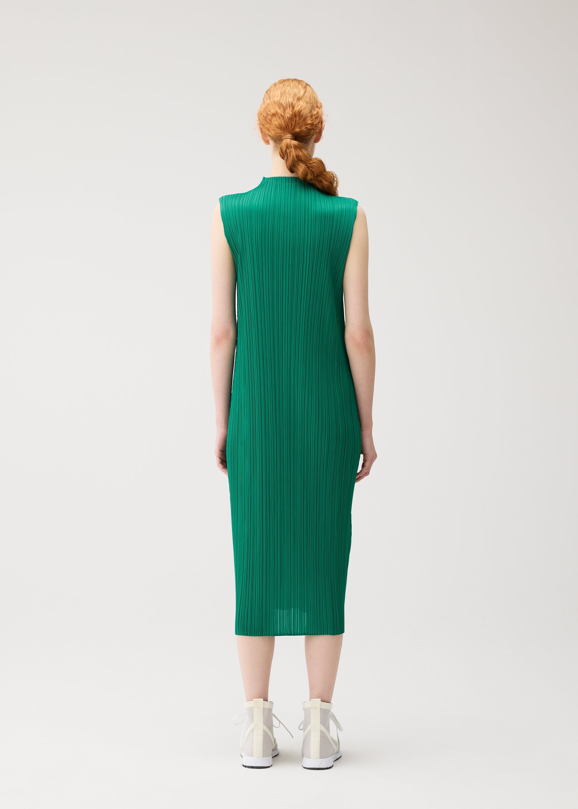A model wears the PLEATS PLEASE ISSEY MIYAKE MONTHLY COLORS : JULY monthly-colors-july-dress-pale-orange-1.