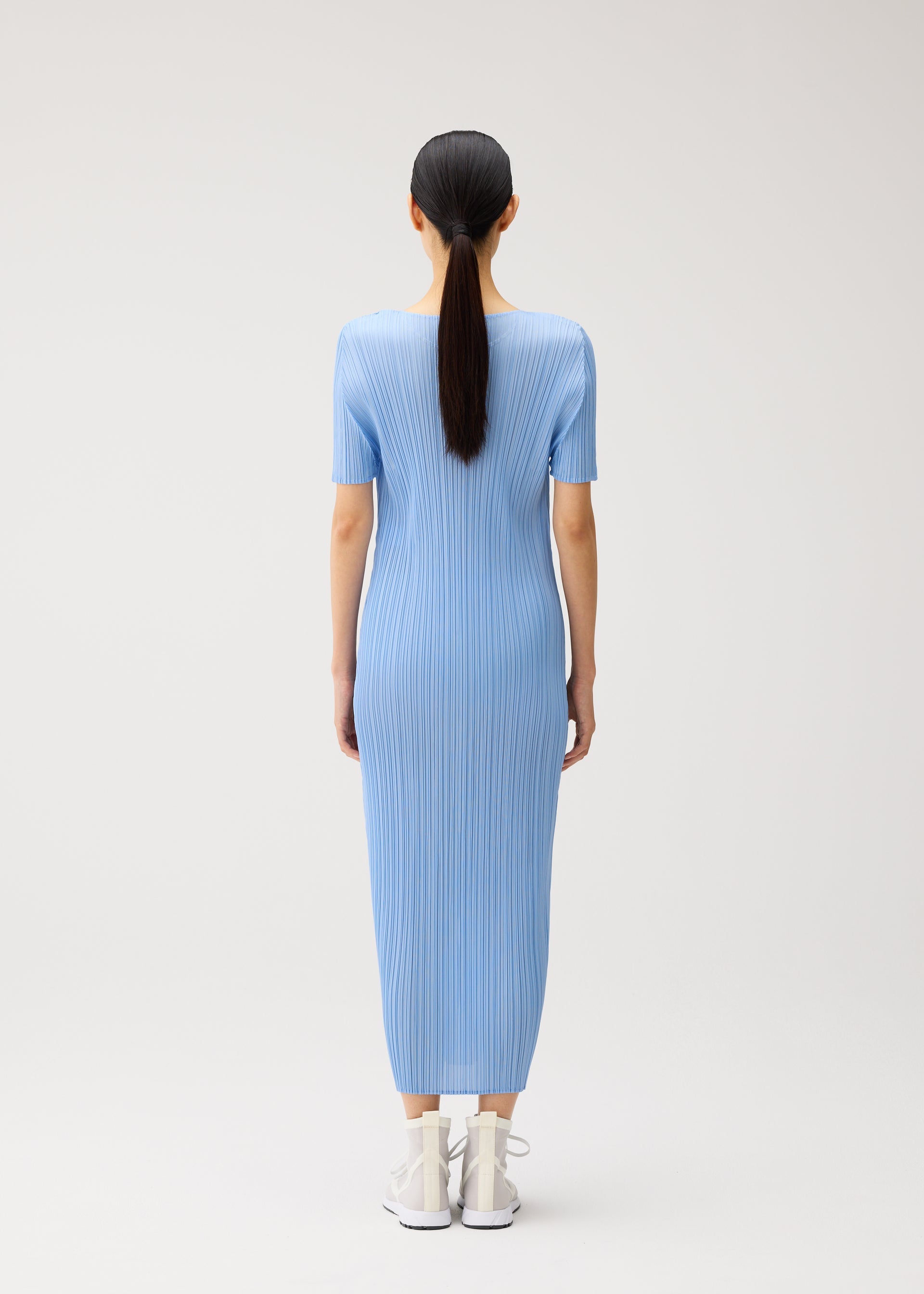 A model wears the PLEATS PLEASE ISSEY MIYAKE MONTHLY COLORS : AUGUST monthly-colors-august-dress-greyish-green.