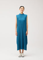A model wears the PLEATS PLEASE ISSEY MIYAKE MELLOW PLEATS dress.