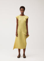 A model wears the PLEATS PLEASE ISSEY MIYAKE LEAP leap-dress-forest-green.