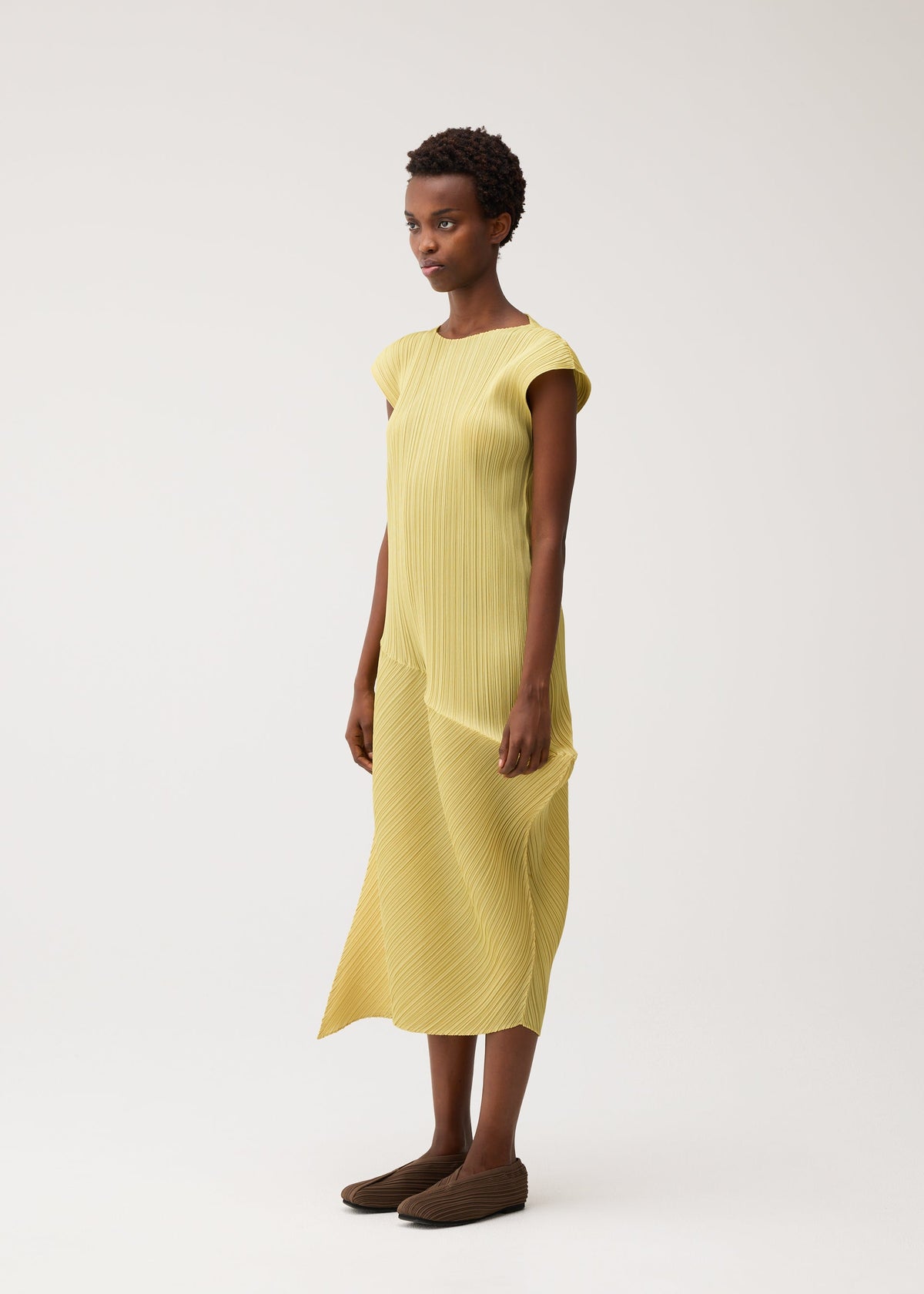A model wears the PLEATS PLEASE ISSEY MIYAKE LEAP dress.