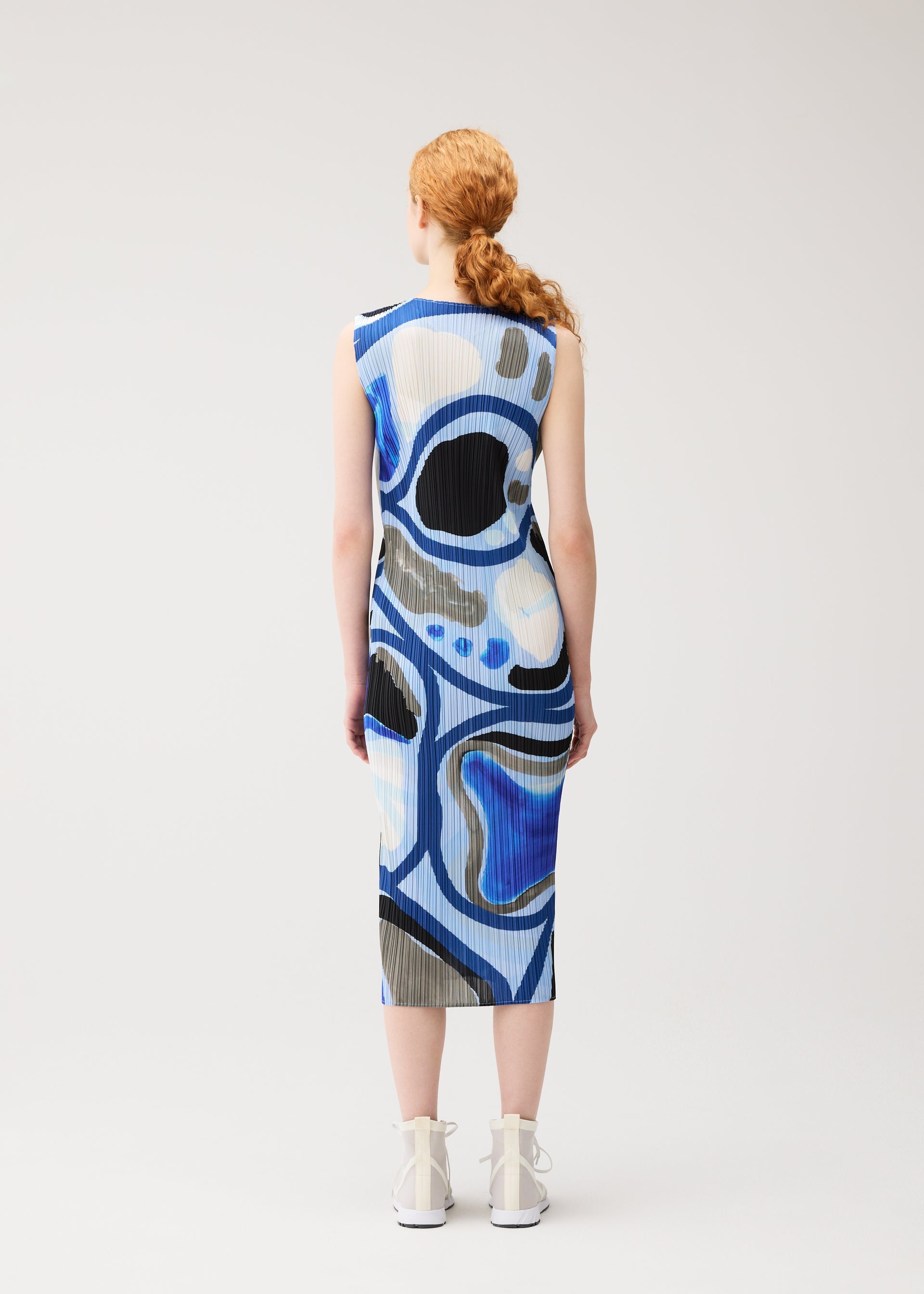 A model wears the PLEATS PLEASE ISSEY MIYAKE ROLL roll-dress-multi-1.