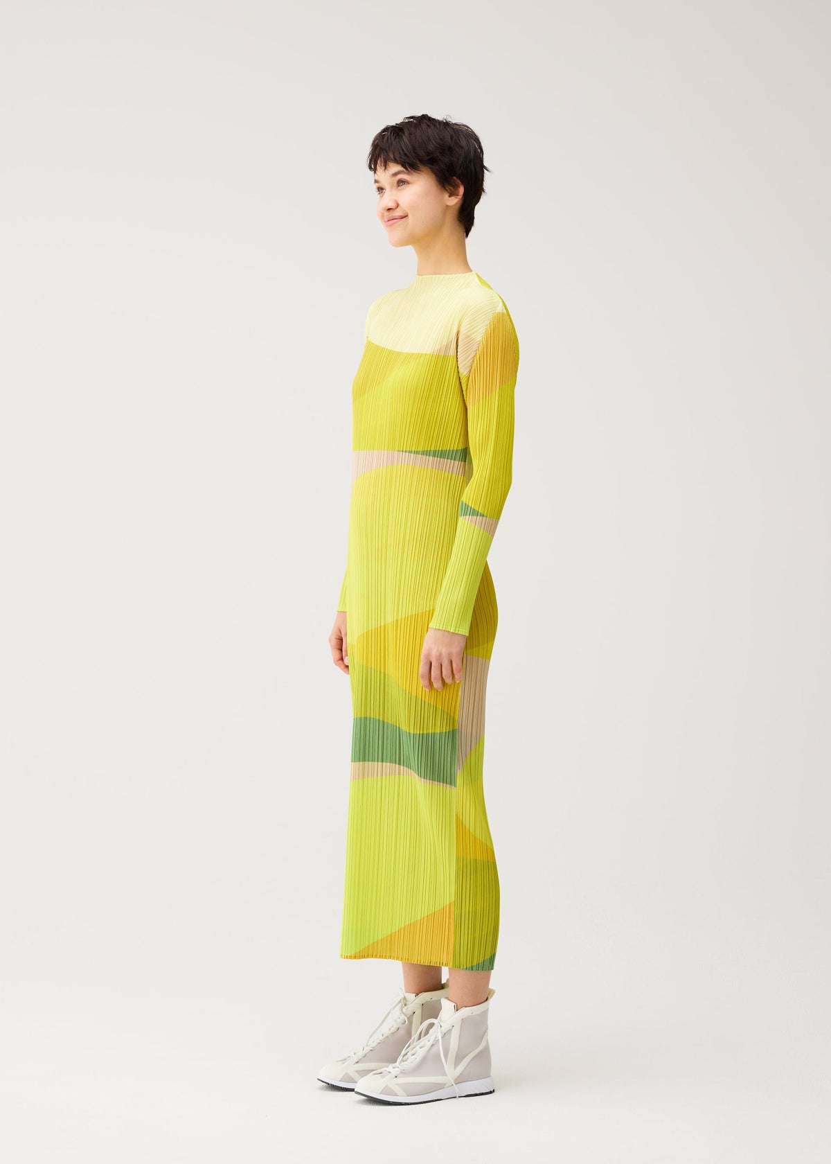 A model wears the PLEATS PLEASE ISSEY MIYAKE ORBIT dress.