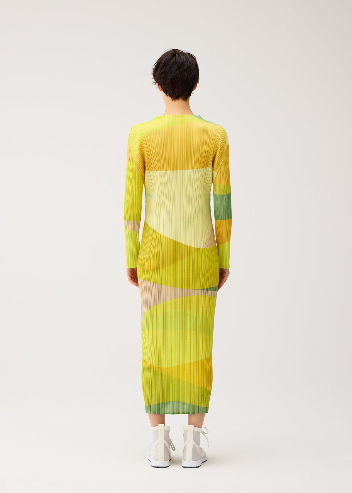A model wears the PLEATS PLEASE ISSEY MIYAKE ORBIT dress.
