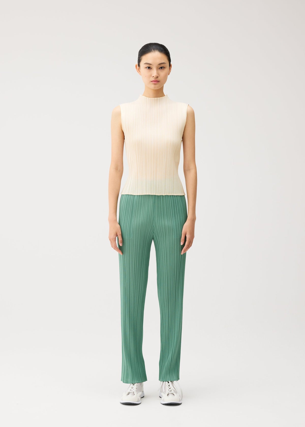 A model wears the PLEATS PLEASE ISSEY MIYAKE MONTHLY COLORS : AUGUST monthly-colors-august-shirt-greyish-green.