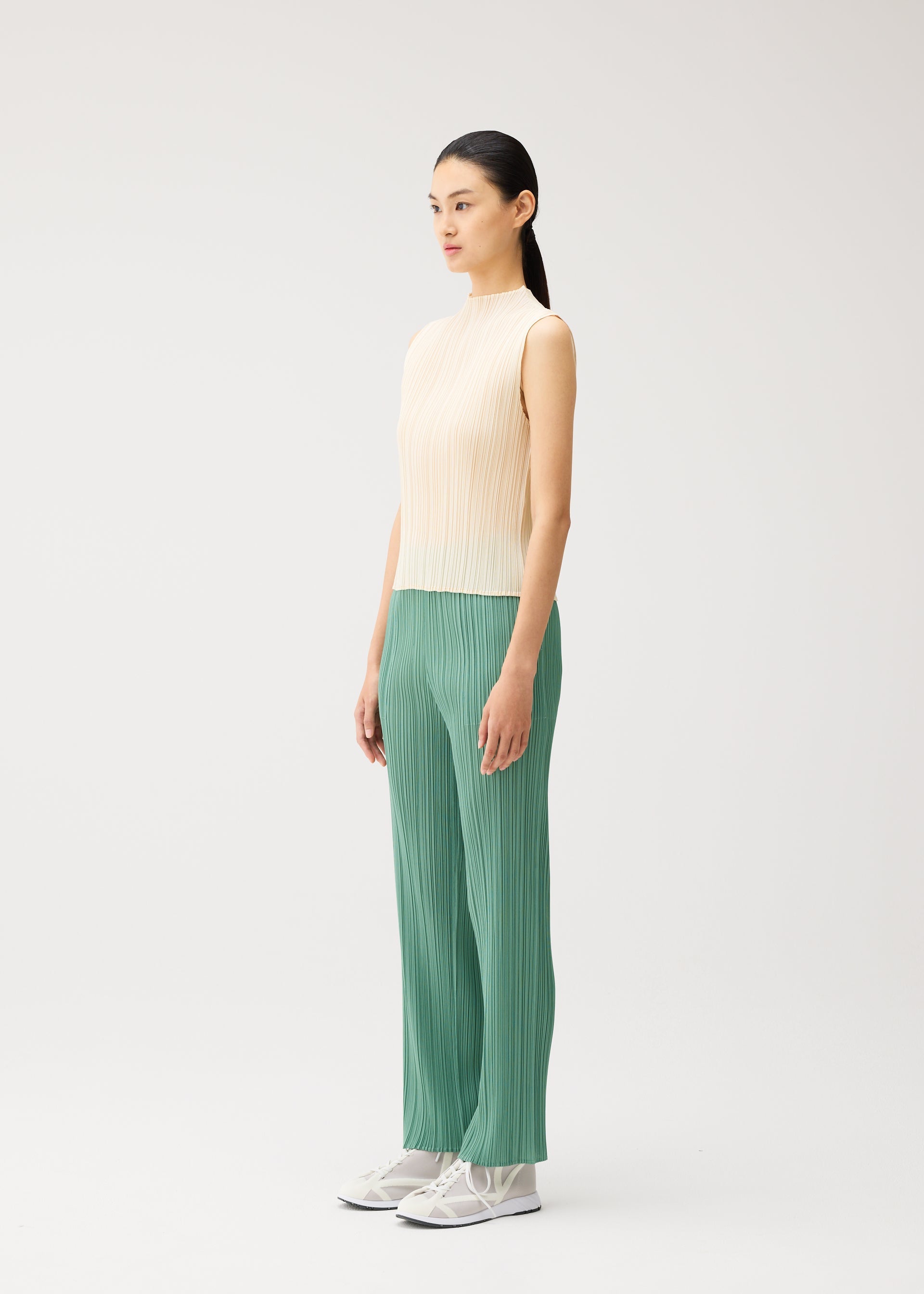 A model wears the PLEATS PLEASE ISSEY MIYAKE MONTHLY COLORS : AUGUST monthly-colors-august-shirt-greyish-green.