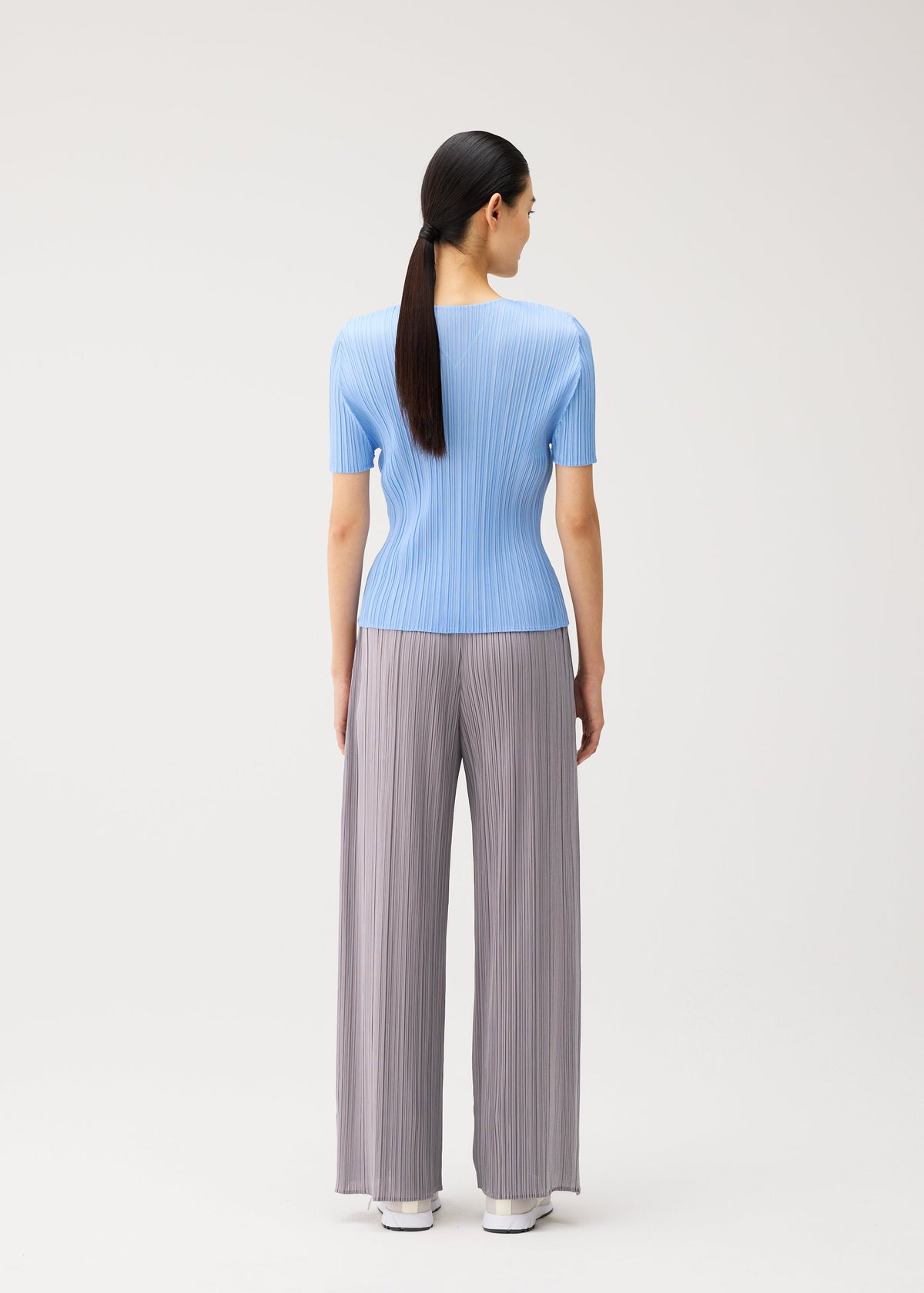A model wears the PLEATS PLEASE ISSEY MIYAKE MONTHLY COLORS : AUGUST monthly-colors-august-shirt-light-blue-1.