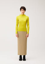 A model wears the PLEATS PLEASE ISSEY MIYAKE MONTHLY COLORS : OCTOBER monthly-colors-october-shirt-ash-beige.