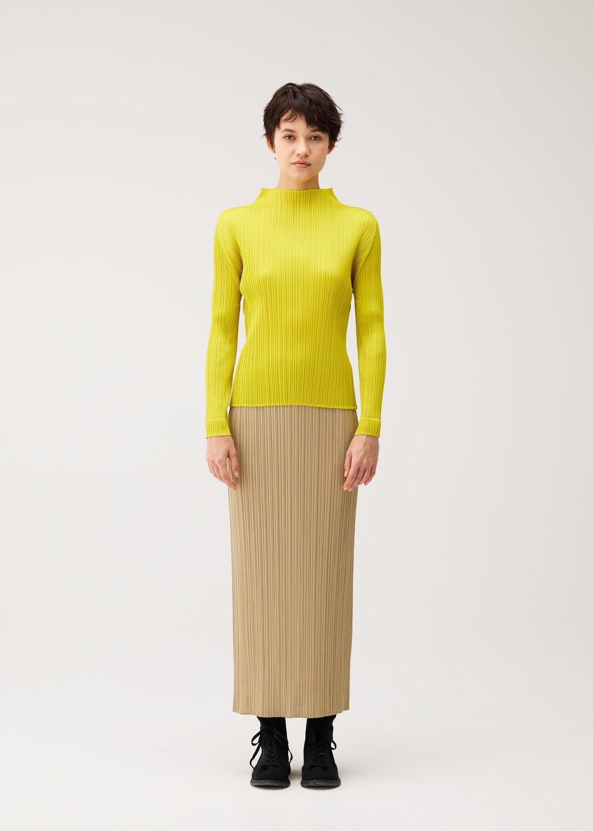 A model wears the PLEATS PLEASE ISSEY MIYAKE MONTHLY COLORS : OCTOBER monthly-colors-october-shirt-ash-beige.