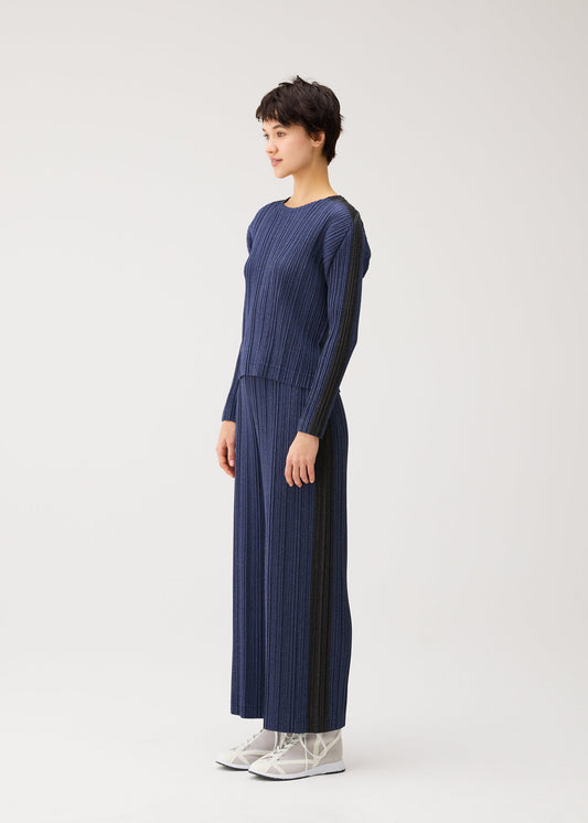 A model wears the PLEATS PLEASE ISSEY MIYAKE COTTON DENIM shirt.