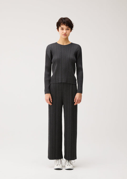 A model wears the PLEATS PLEASE ISSEY MIYAKE COTTON DENIM BLACK cotton-denim-black-shirt-black.