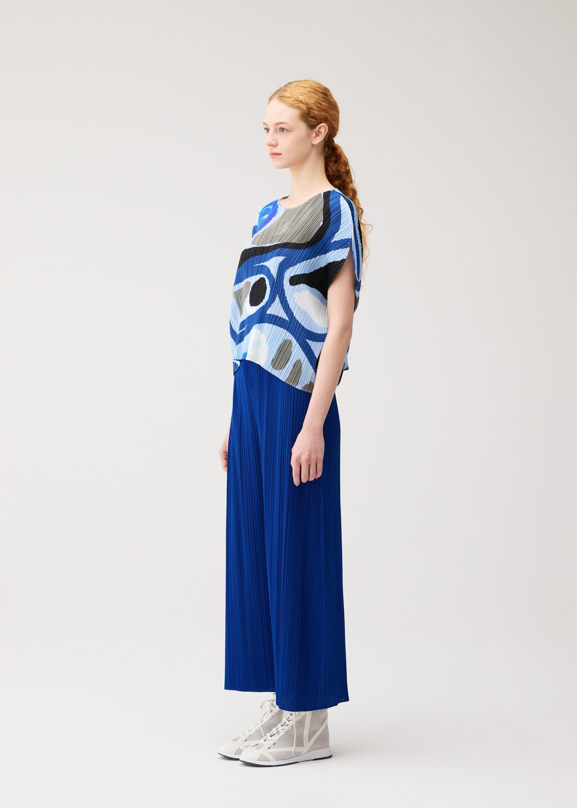 A model wears the PLEATS PLEASE ISSEY MIYAKE ROLL roll-shirt-multi-3.