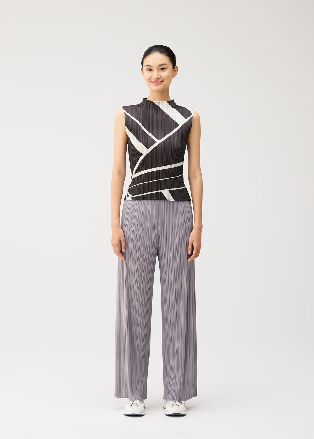 A model wears the PLEATS PLEASE ISSEY MIYAKE FOLD LINE fold-line-shirt-charcoal.