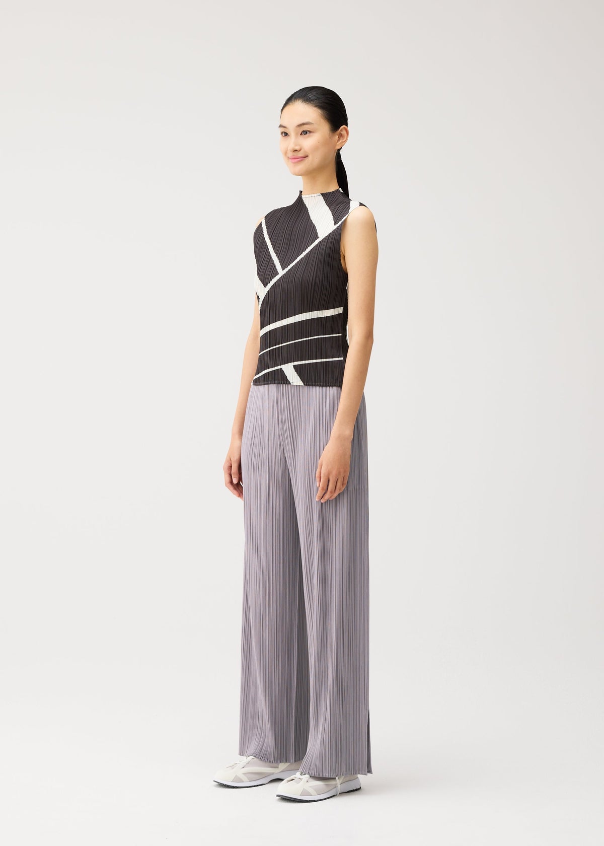 A model wears the PLEATS PLEASE ISSEY MIYAKE FOLD LINE fold-line-shirt-charcoal.