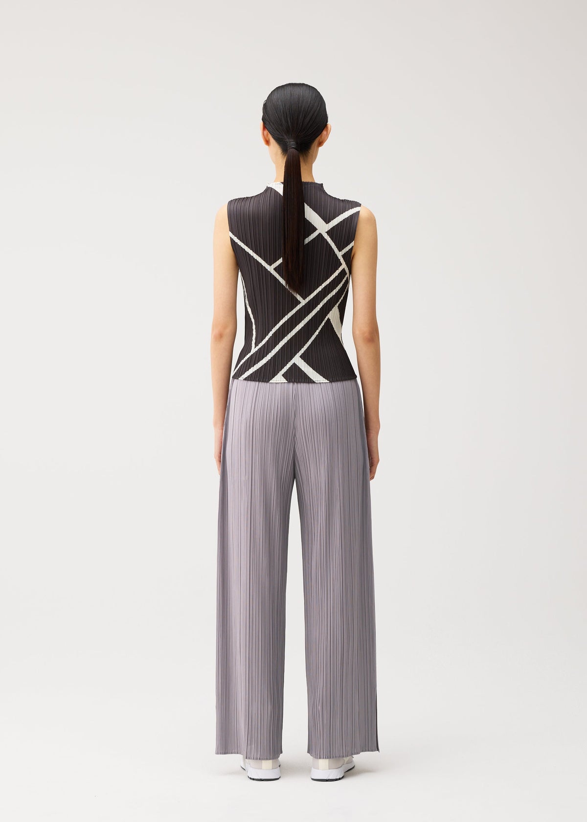 A model wears the PLEATS PLEASE ISSEY MIYAKE FOLD LINE fold-line-shirt-charcoal.