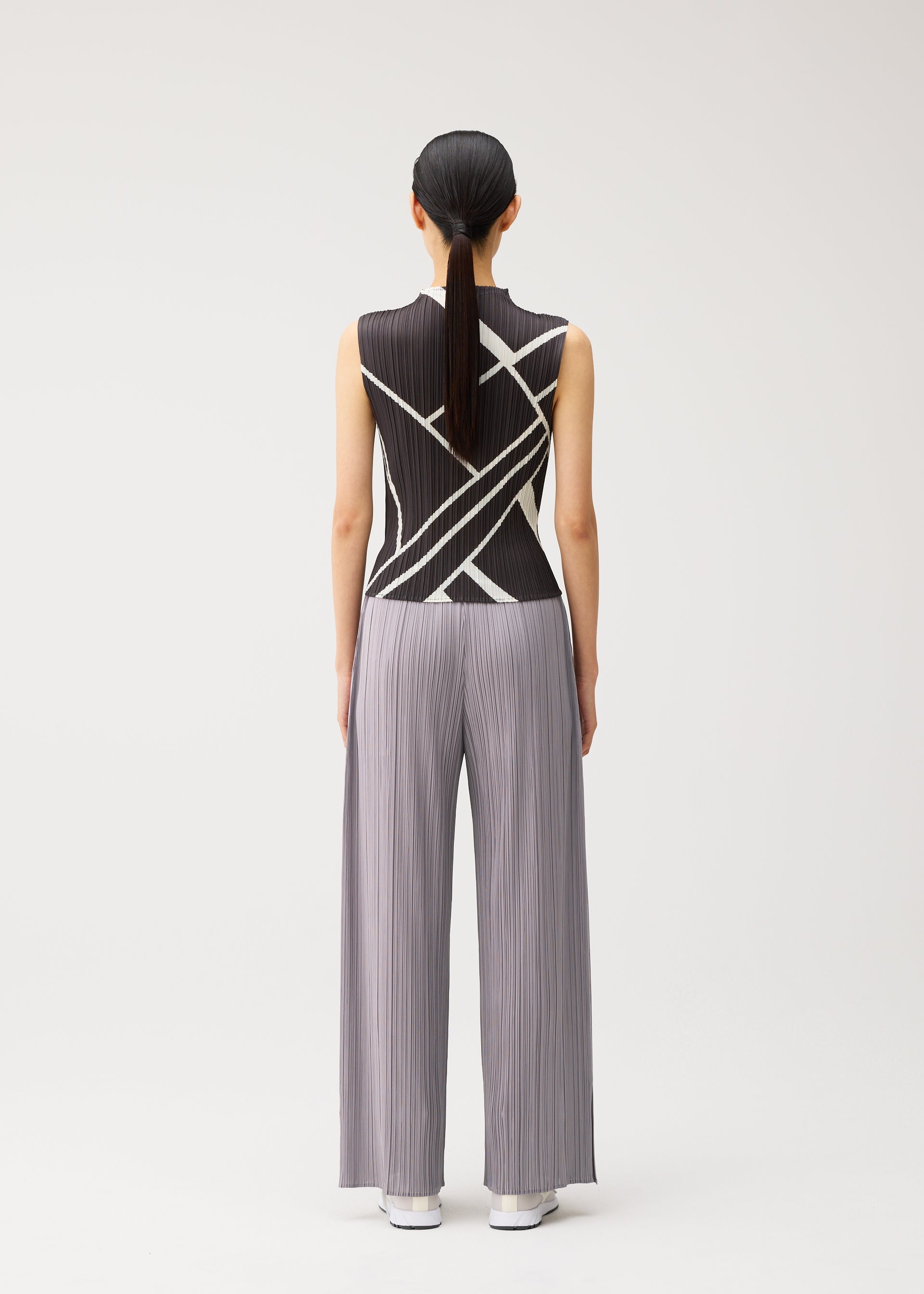 A model wears the PLEATS PLEASE ISSEY MIYAKE FOLD LINE fold-line-shirt-charcoal.