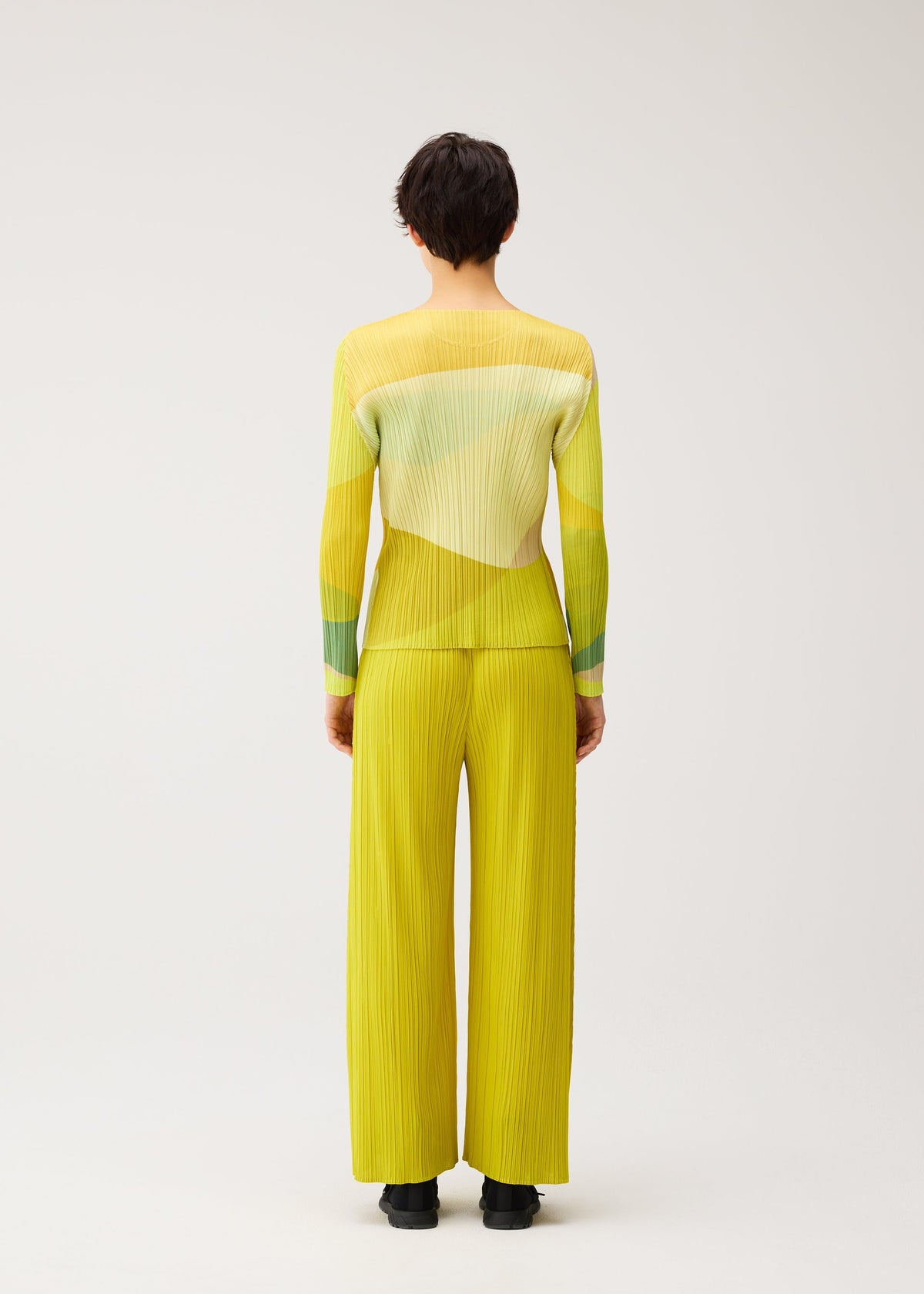 A model wears the PLEATS PLEASE ISSEY MIYAKE ORBIT shirt.