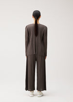 A model wears the PLEATS PLEASE ISSEY MIYAKE MELLOW PLEATS cardigan.