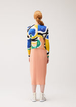A model wears the PLEATS PLEASE ISSEY MIYAKE ROLL roll-cardigan-multi-1.