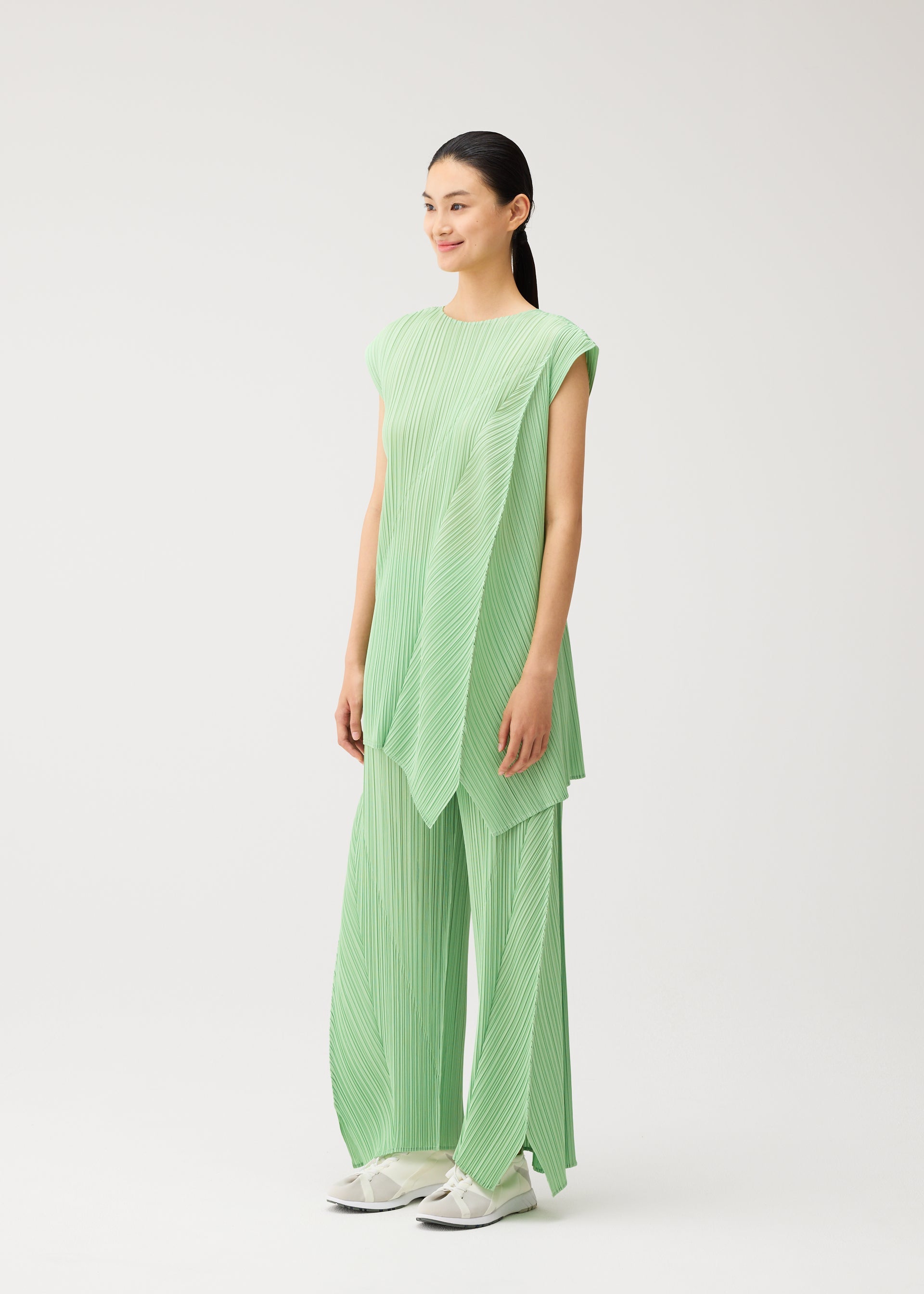 A model wears the PLEATS PLEASE ISSEY MIYAKE FOLD fold-dress-mint-green-1.