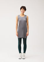 A model wears the PLEATS PLEASE ISSEY MIYAKE A-POC SKIN trousers.