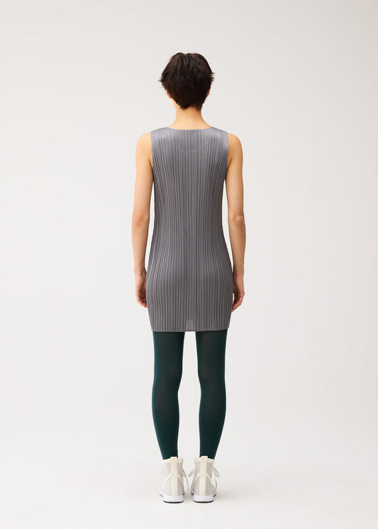 A model wears the PLEATS PLEASE ISSEY MIYAKE A-POC SKIN trousers.
