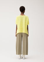 A model wears the PLEATS PLEASE ISSEY MIYAKE PAPER BOUNCE KNIT paper-bounce-knit-shirt-black-1.