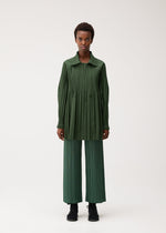 A model wears the PLEATS PLEASE ISSEY MIYAKE SMOOTH COAT coat.