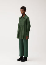 A model wears the PLEATS PLEASE ISSEY MIYAKE SMOOTH COAT coat.
