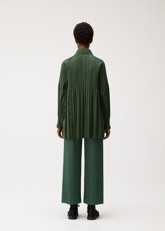 A model wears the PLEATS PLEASE ISSEY MIYAKE SMOOTH COAT coat.