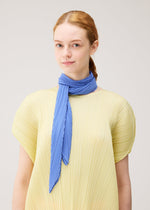 A model wears the PLEATS PLEASE ISSEY MIYAKE SKINNY SCARF skinny-scarf-stole-white.
