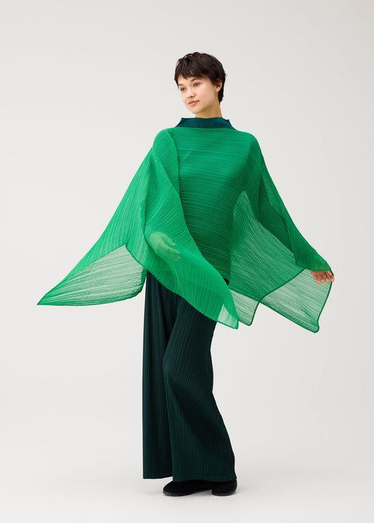 A model wears the PLEATS PLEASE ISSEY MIYAKE MADAME-T OCTOBER madame-t-october-stole-yellow-ochre.