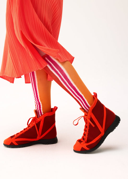 A model wears the PLEATS PLEASE ISSEY MIYAKE WOW! SOCKS socks.