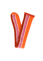 A product shot of the PLEATS PLEASE ISSEY MIYAKE WOW! SOCKS socks in orange.