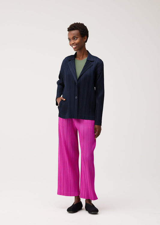 A model wears the PLEATS PLEASE ISSEY MIYAKE KNIT BALLET SHOES shoes.