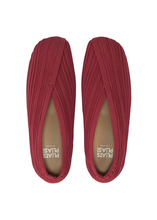 A detail shot of the PLEATS PLEASE ISSEY MIYAKE KNIT BALLET SHOES shoes.